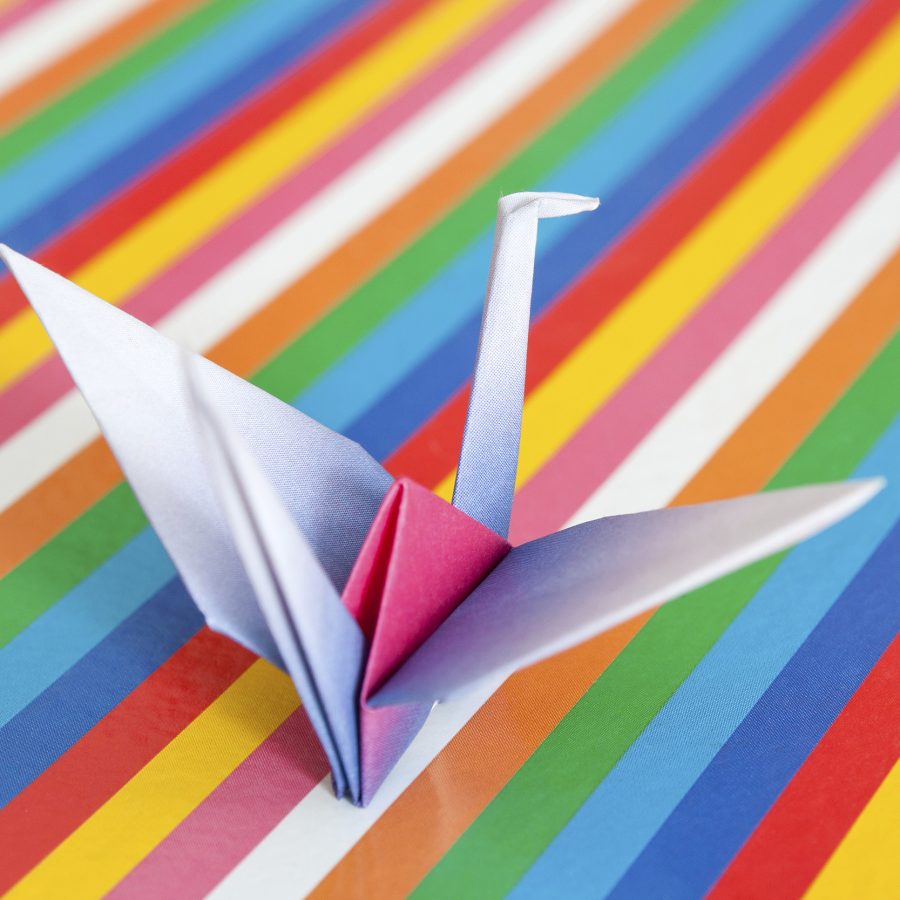 Origami bird on a colorful background.